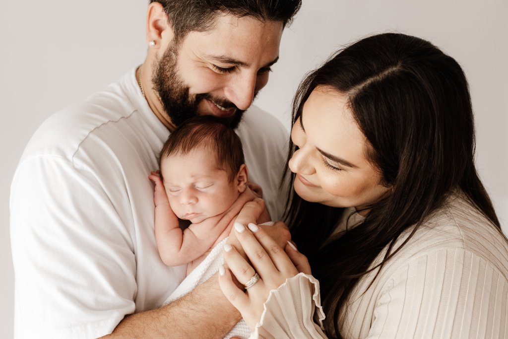 Mum and dad cuddling newborn baby, studio newborn photography Perth