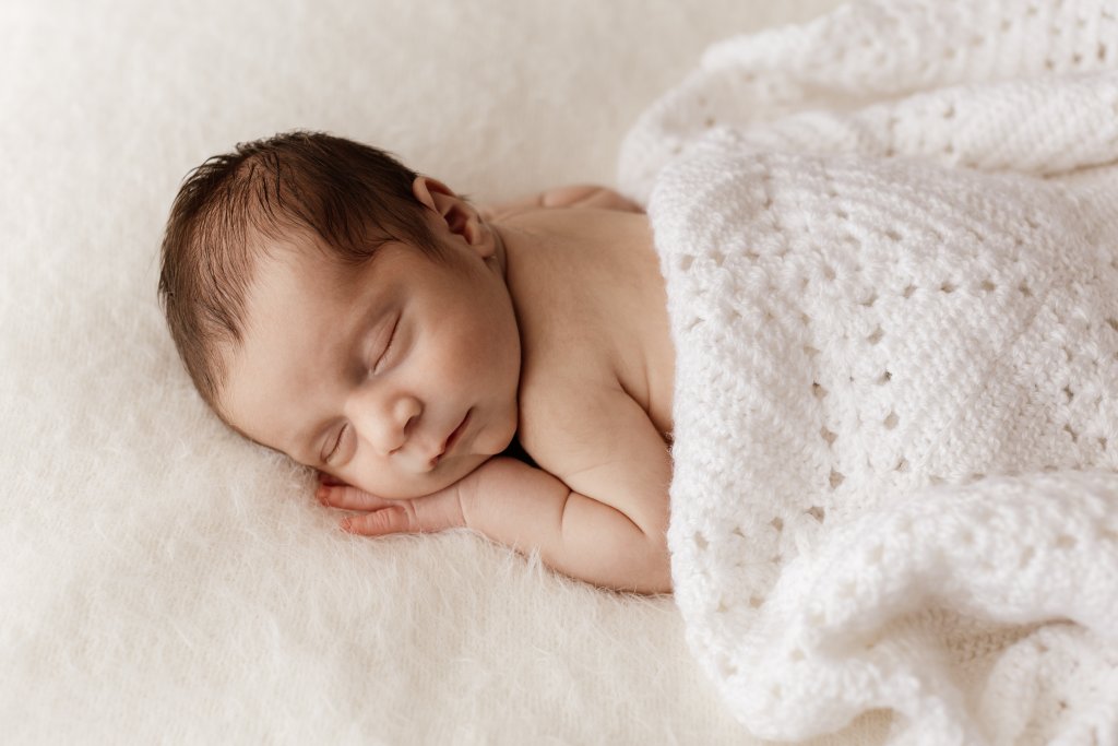 Newborn baby swaddled and sleeping during Perth newborn photography session