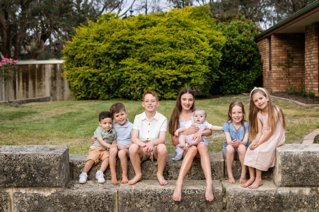 Large extended family photographed outdoors in Perth during a multi generation family session