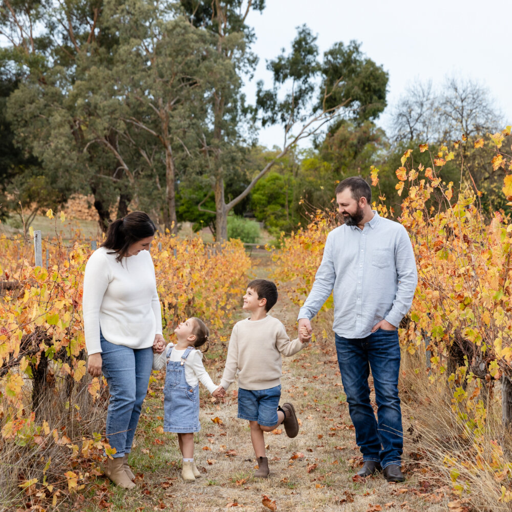 family of four walking through autumn vineyard, family photography Perth