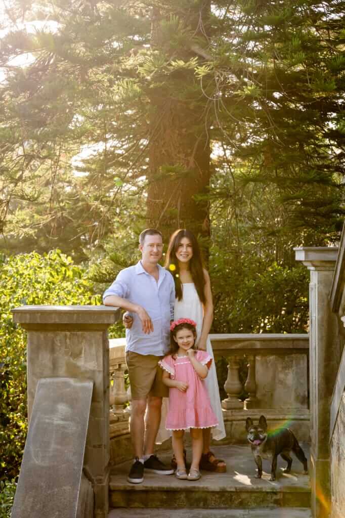 family standing together on stone steps with their French Bulldog during a family and dog photography Perth session.