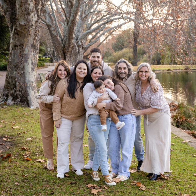 extended family group hugging in autumn hyde park, family photoshoot Perth