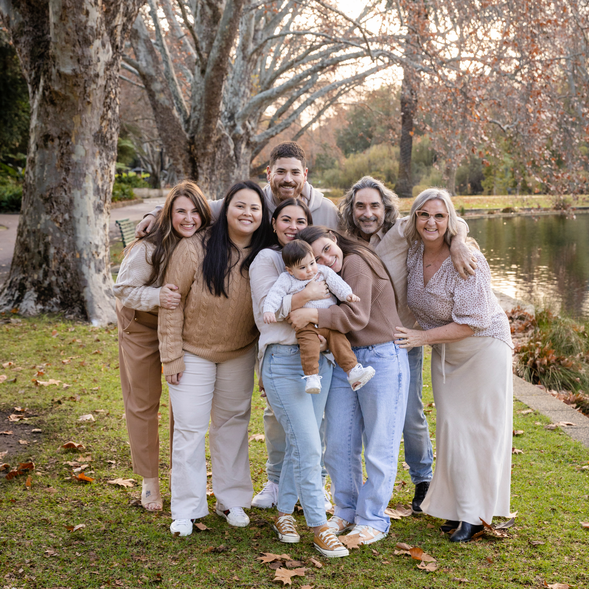 extended family group hugging in autumn hyde park, family photoshoot Perth