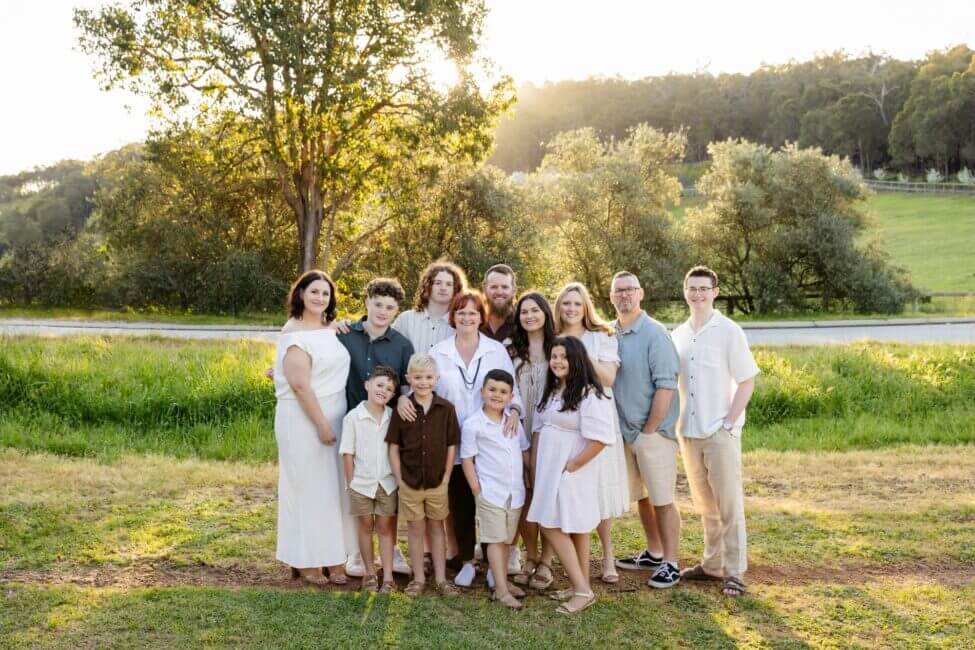 large extended family group at golden hour in green paddock, family photoshoot Perth Hills