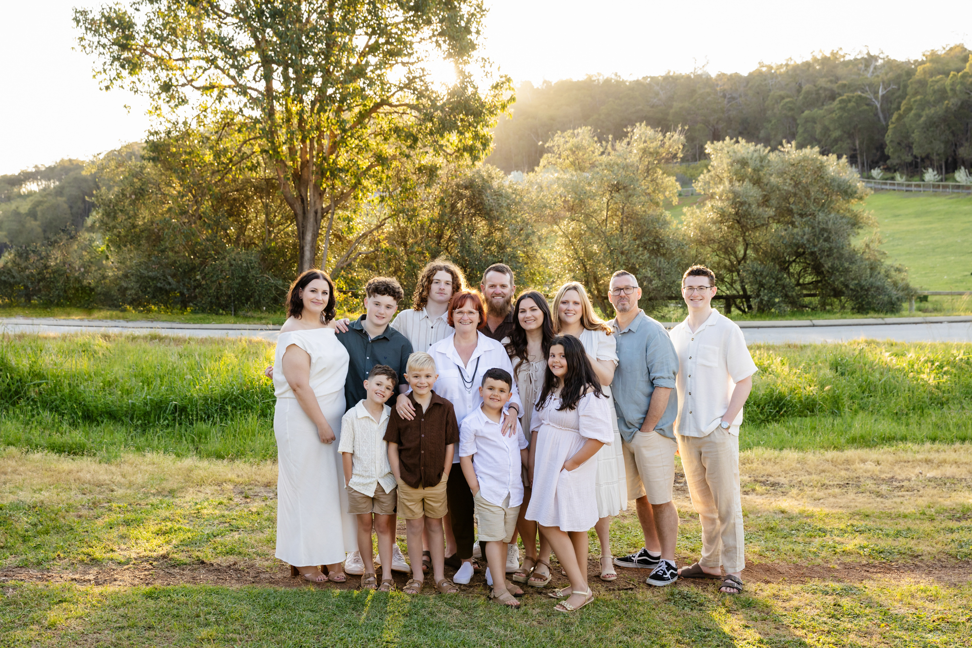 large extended family group at golden hour in green paddock, family photoshoot Perth Hills