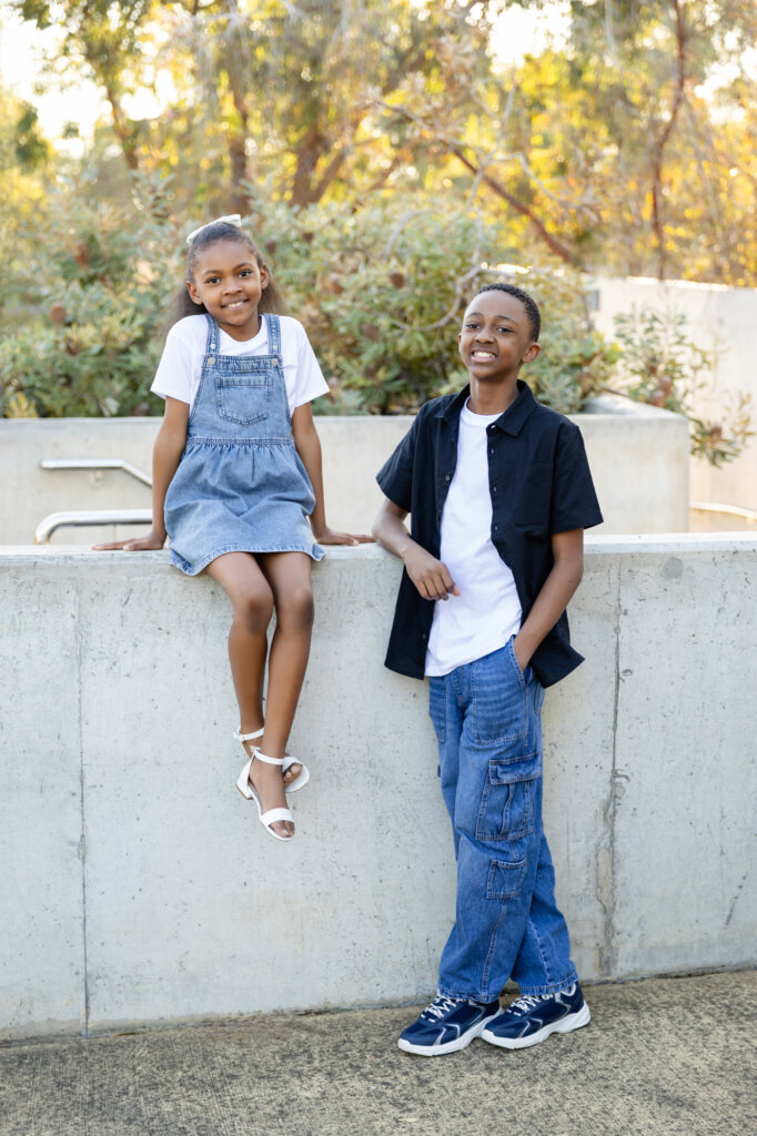 Two siblings posing together outdoors at golden hour - Perth family photography