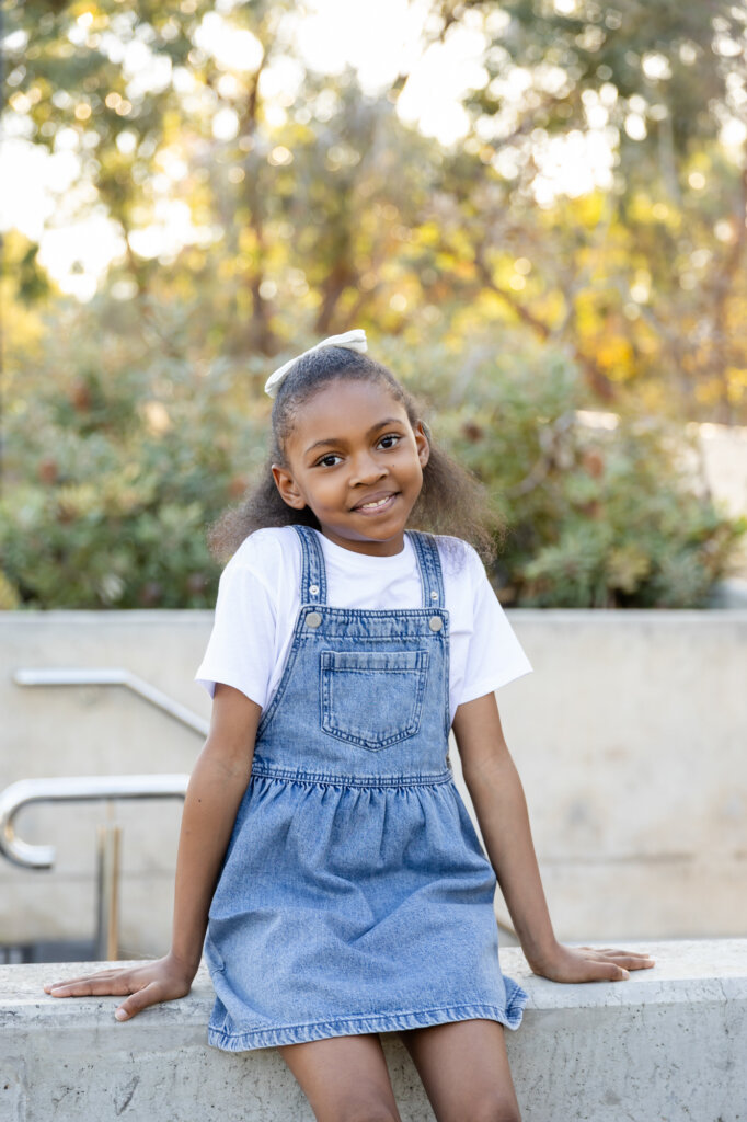 Young girl in denim pinafore, outdoor children's portrait Perth