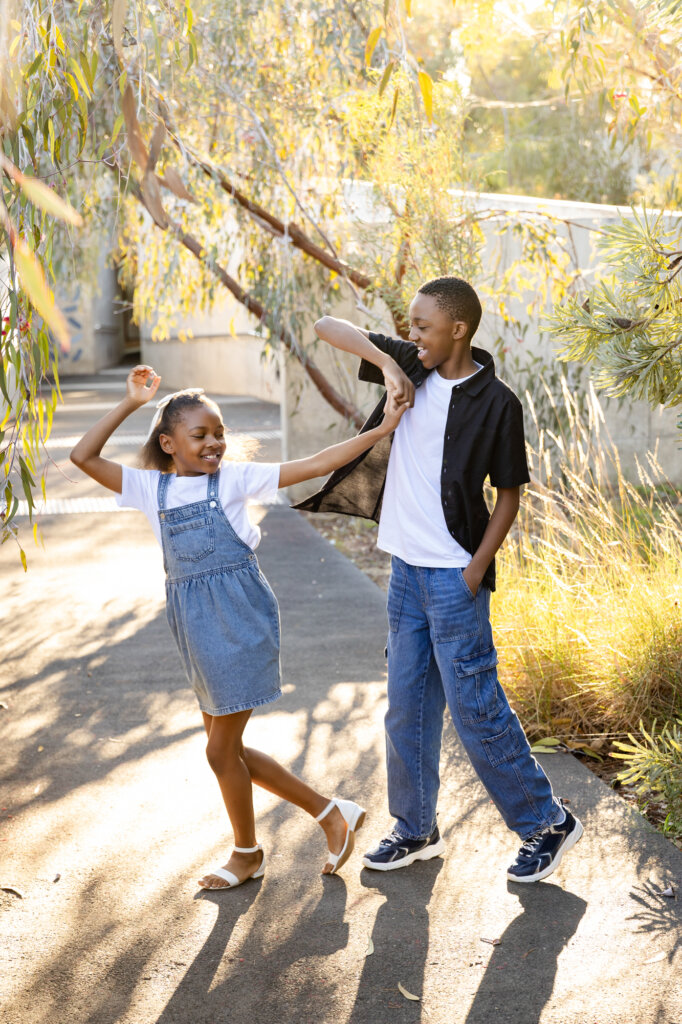 Brother and sister dancing, candid sibling portrait Perth