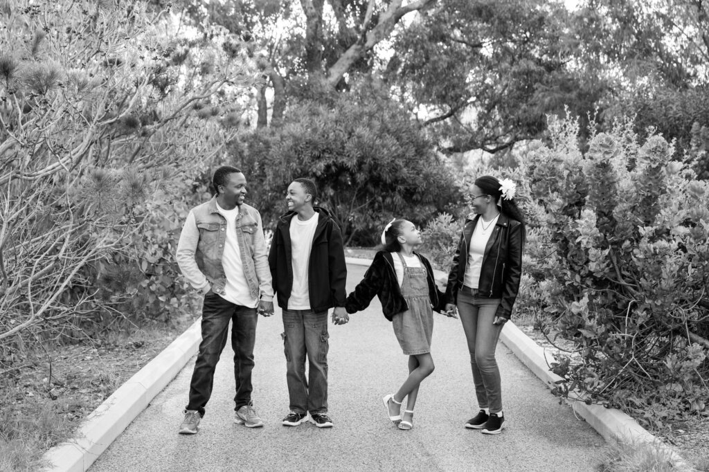 family of four holding hands and smiling at each, Perth family portraits
