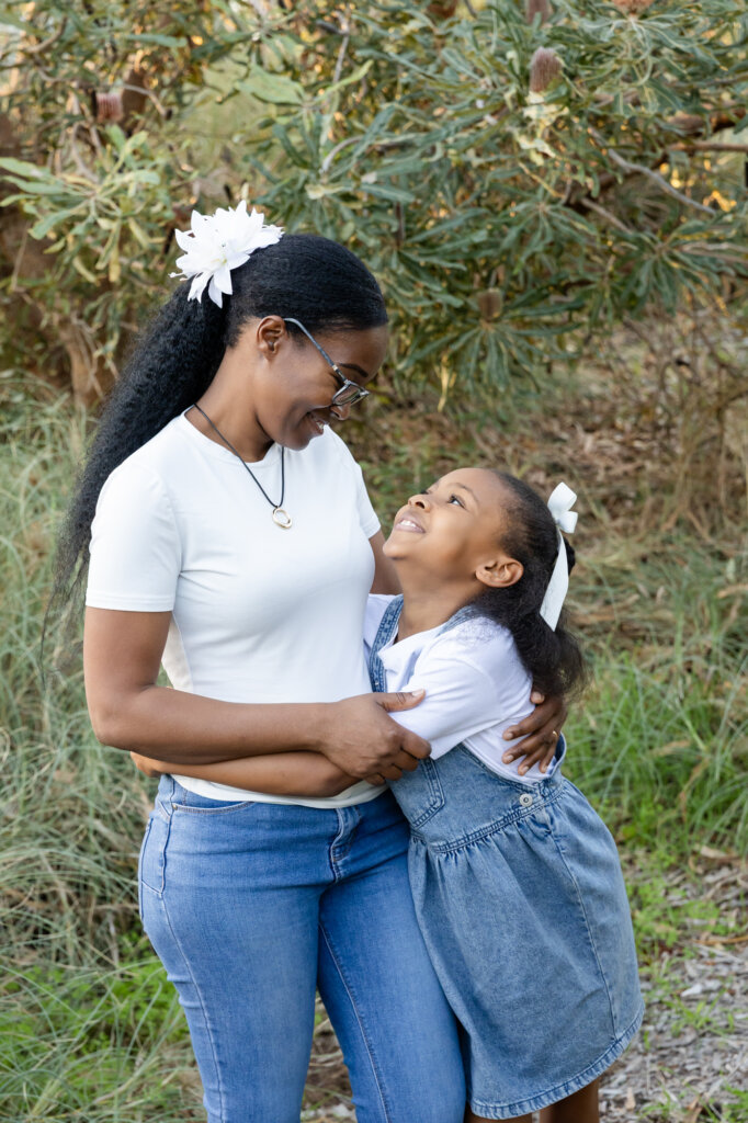 Mum and young daughter looking at each other and laughing, tender mother daughter portrait Perth
